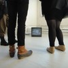 Upstairs at PS1, viewers take in the hype-saturated Laurel Nakadate exhibit.